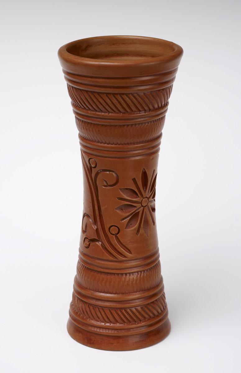 Tall terracotta vase with inscribed flower and scroll motif